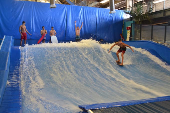Kids waiting for Flowrider with one rider