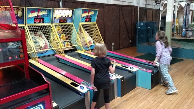 Kids playing Skee Ball