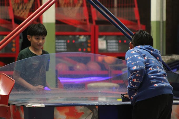 Kids playing table hockey